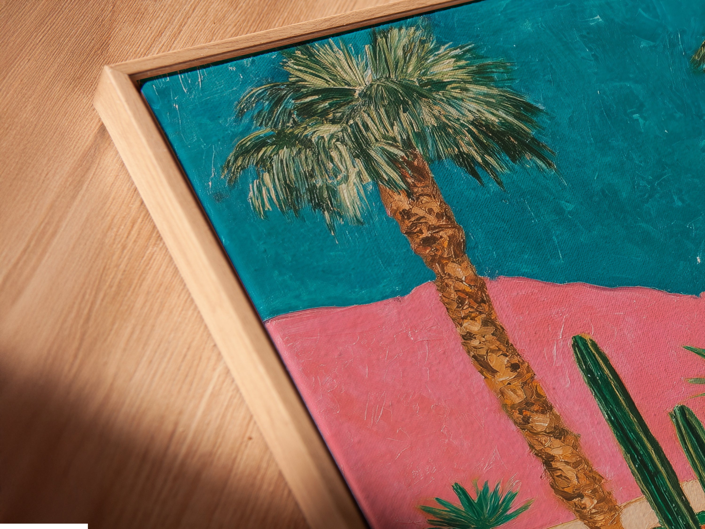 A close-up angled view of a canvas print in a floating frame. The retro Palm Springs artwork showcases a vintage car and desert landscape. The floating frame gives the illusion that the art is floating. This adds a modern touch to the mid-century modern piece.