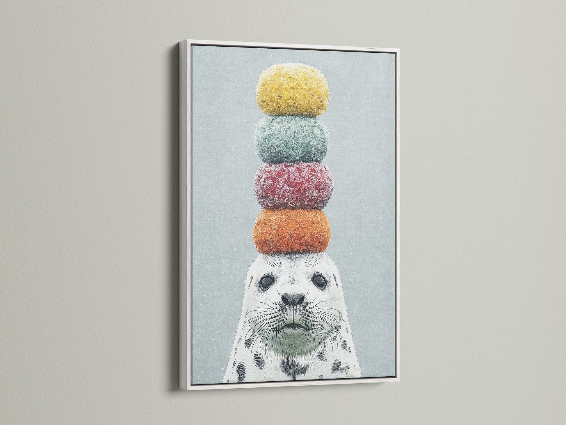 The framed canvas print showcases a cute seal artwork with macarons. The art is framed in a sleek white frame. This charming piece is perfect for adding a pop of color to a nursery or playroom. Discover the beauty of whimsical animal art.
