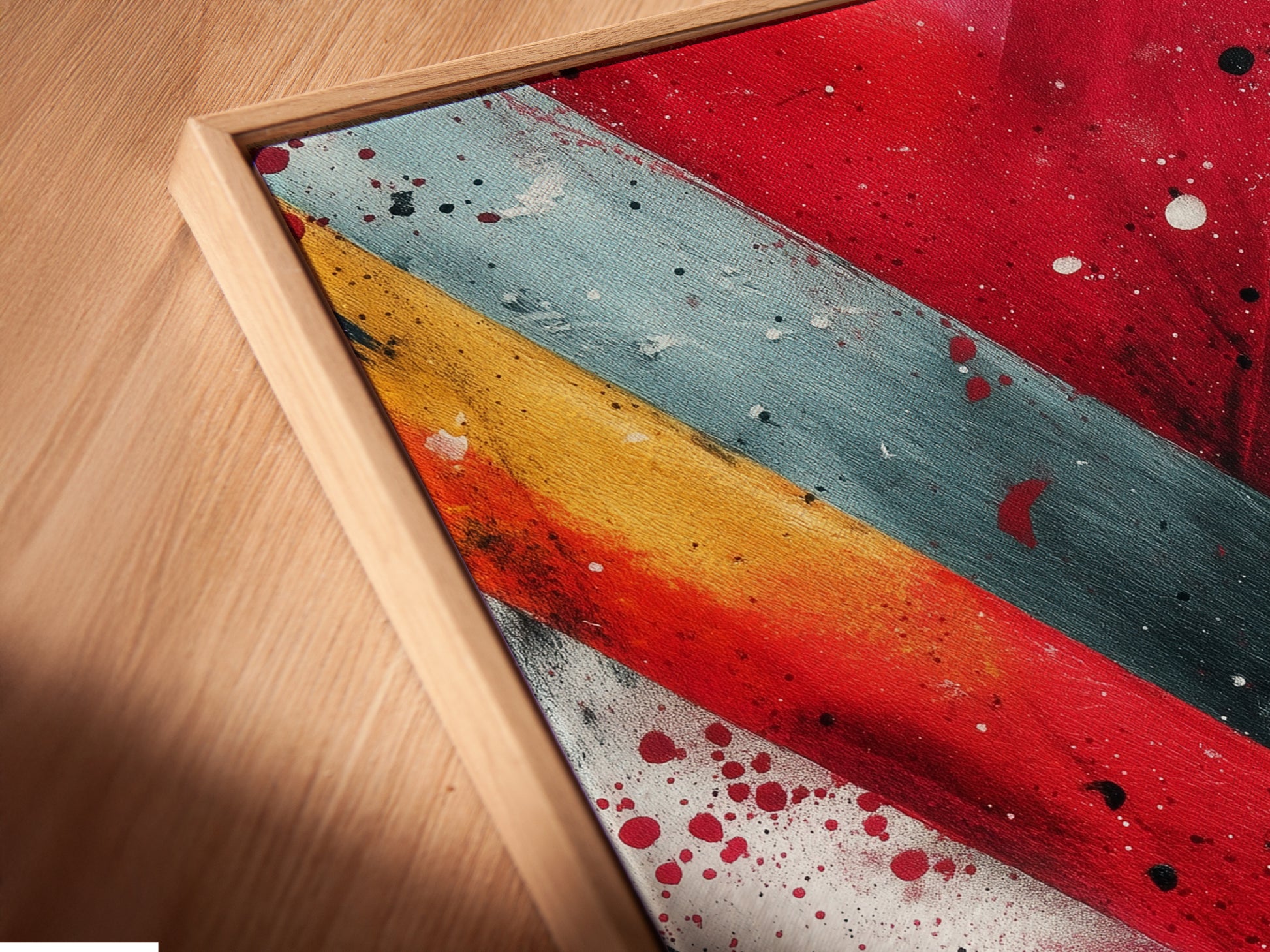 Get a detailed view of our canvas print in a floating frame. See the texture and quality of the artwork up close. The red and teal abstract art adds a modern touch. Perfect for enhancing any room's decor.