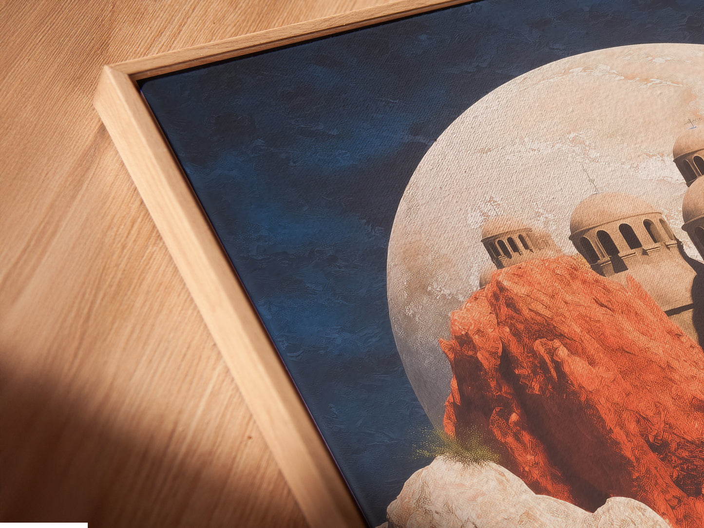 A close up angled view of a canvas print in a floating frame. The fantasy landscape artwork features a dreamy floral field. This unique wall decor enhances any room. It is perfect for homeowners and renters.