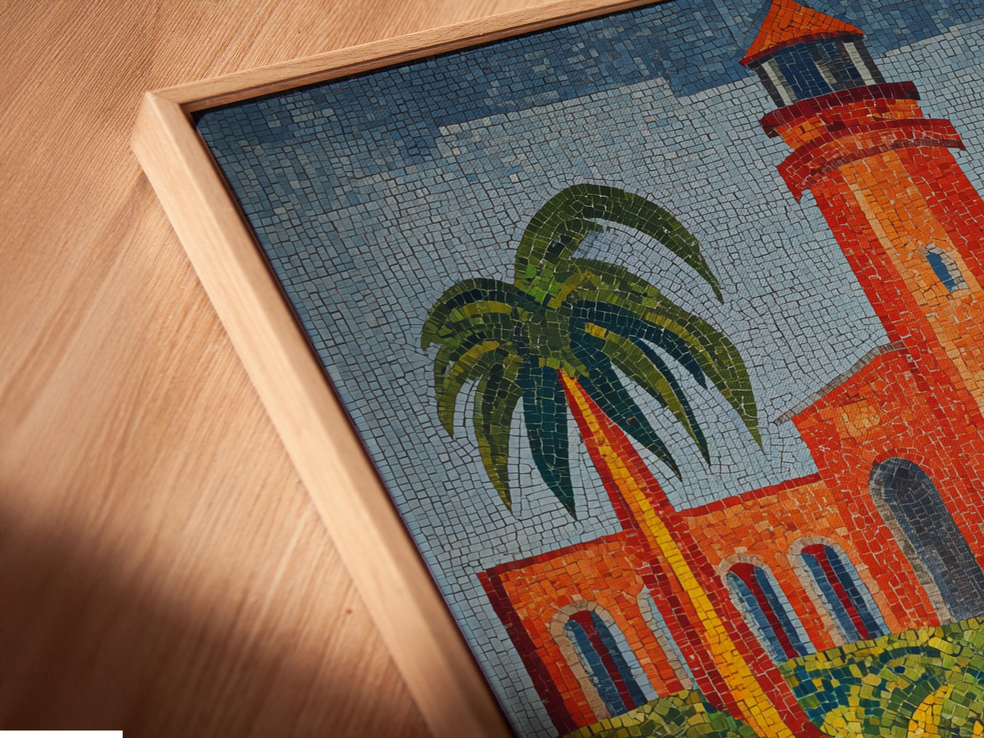 Angled close-up of a canvas print in a floating frame. The lighthouse mosaic art is visible. This coastal wall decor is a Mediterranean delight. The tile art enhances beach house decor. It provides a nautical accent.