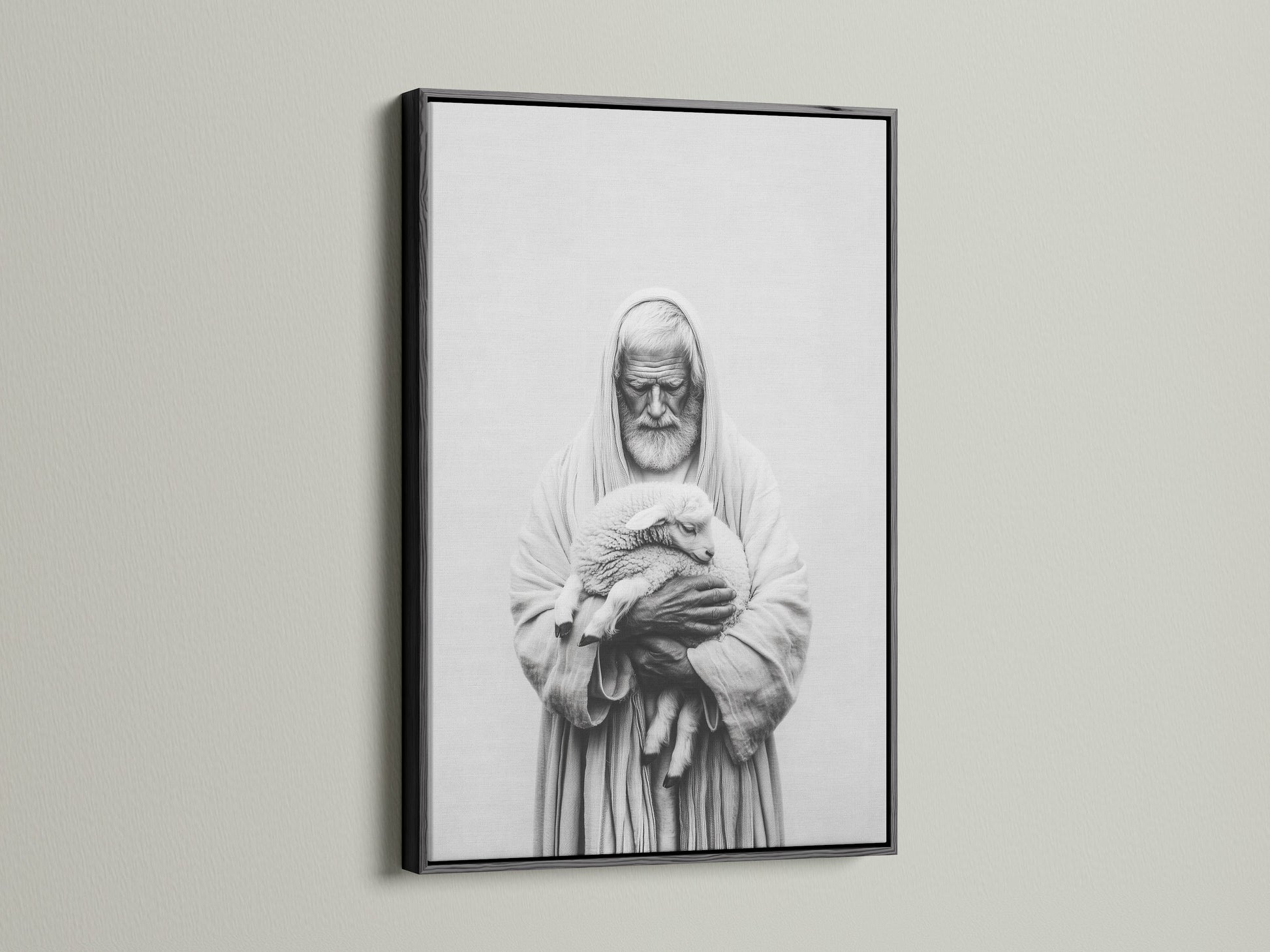 A framed artwork hangs on a light beige wall. The artwork has a black frame. The frame is thin and modern. The art print is a black and white image of a man holding a lamb. This artwork adds a touch of elegance to your home.