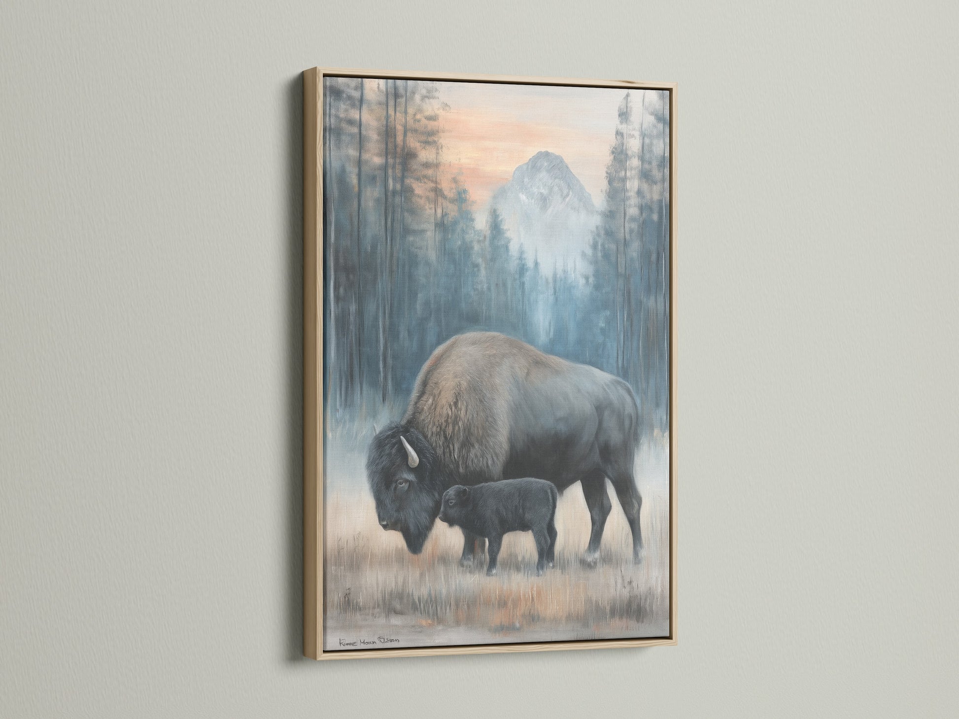 Bison art is displayed in an oak frame. The artwork shows a mother and calf. It adds a touch of nature to your space. This wildlife canvas enhances your rustic decor beautifully.