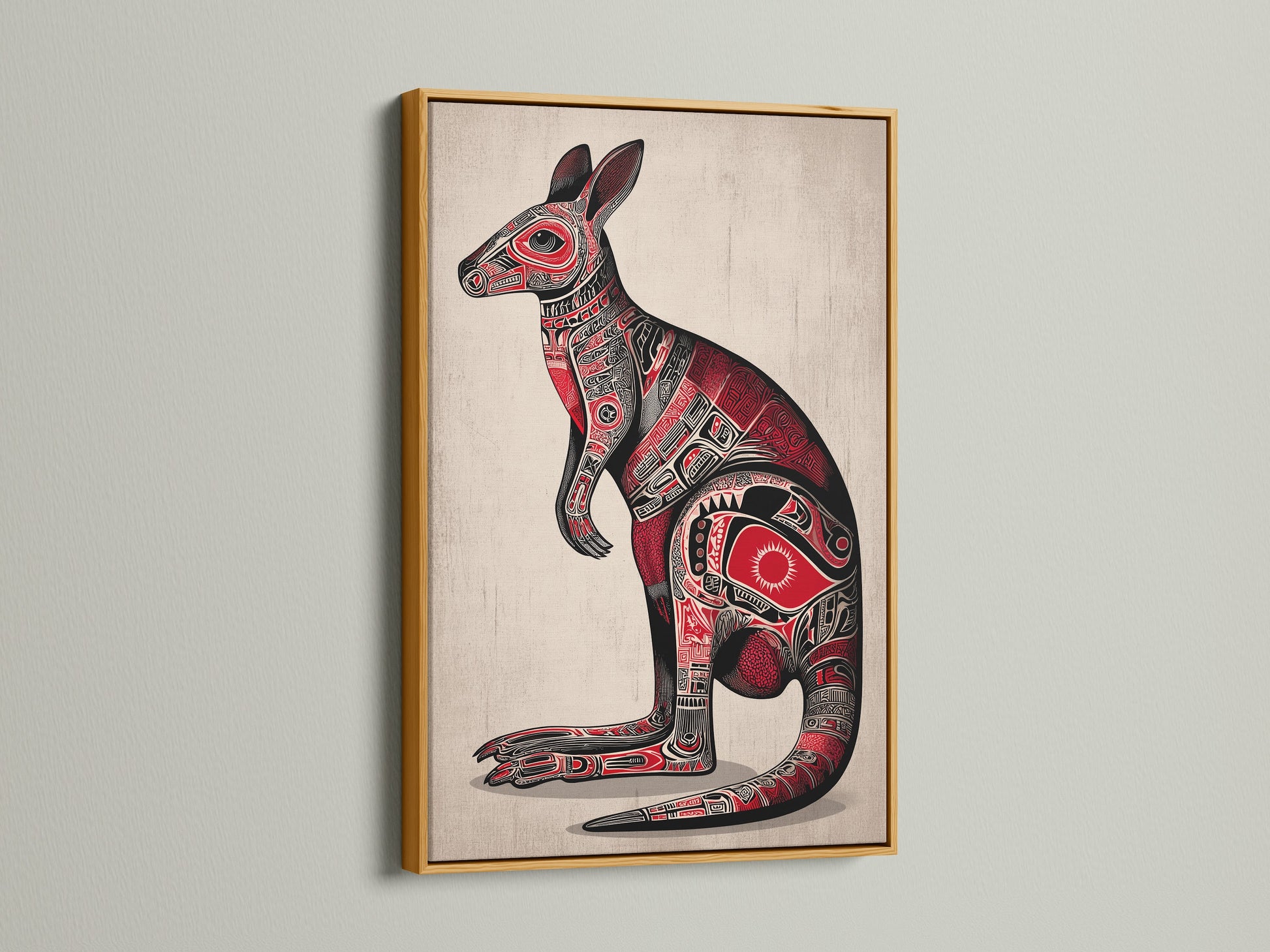 Aboriginal Kangaroo art print in a gold frame. The metallic frame adds a touch of elegance to the tribal artwork. The kangaroo is adorned with indigenous art details. Red and black colors give it a bold look. This piece is a unique cultural artwork.