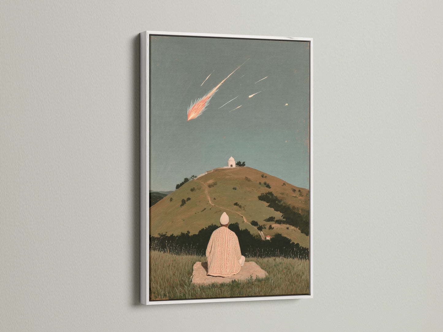 Shooting Star canvas print with a white frame. The artwork depicts a person meditating under a celestial event. Ideal for creating a peaceful environment in your home or studio. The white frame enhances the artwork's calming presence.