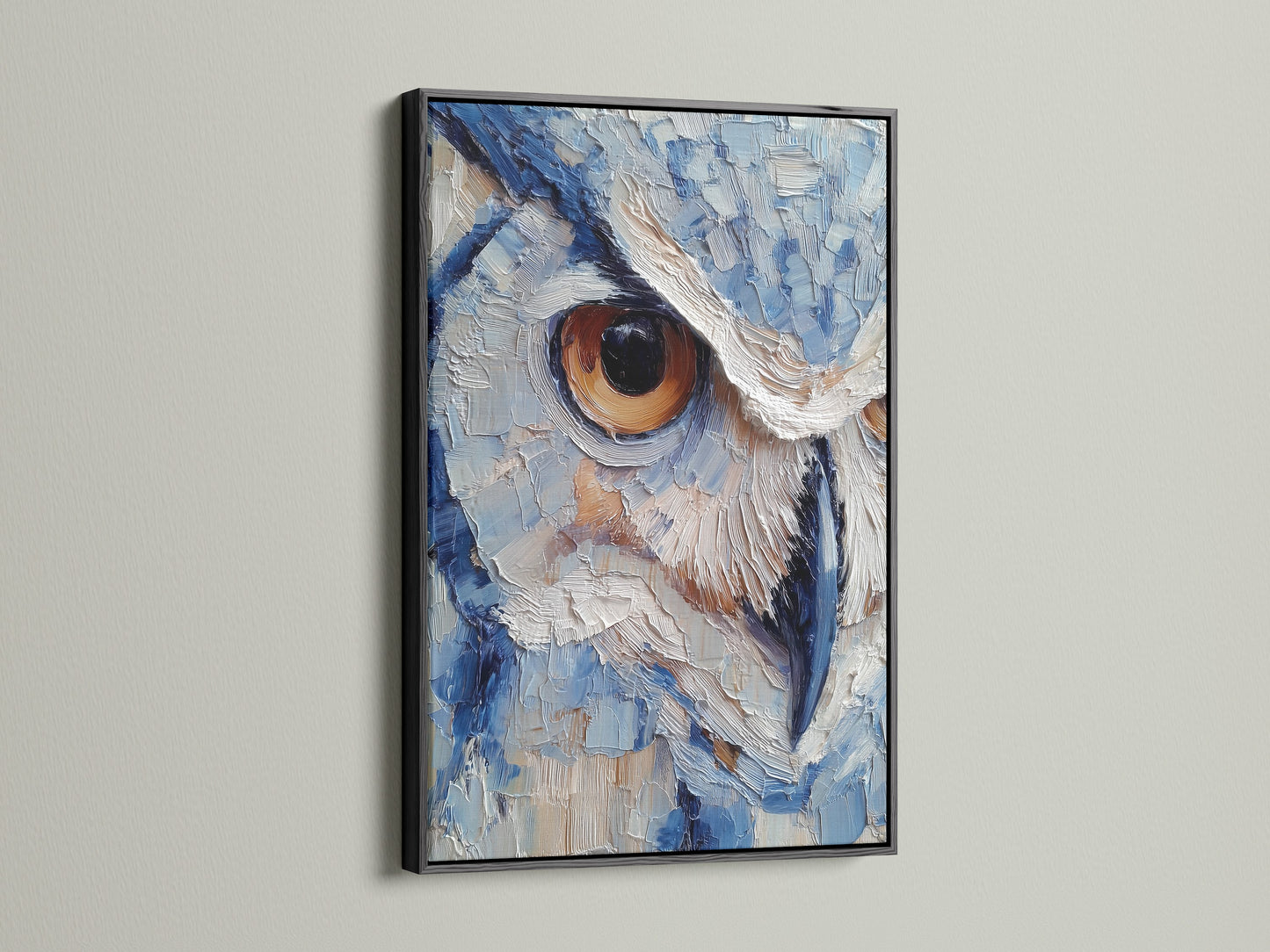 Owl artwork displayed in a sleek black frame. The artwork's intricate details are accentuated by the dark frame. The piece is characterized by its textured painting style. The color palette consists of blues and whites. The owl's intense stare is captivating.