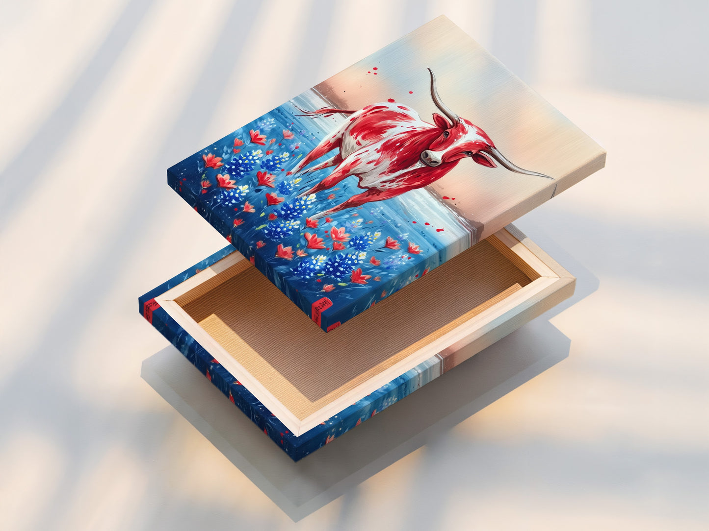 A stretched canvas print of Texas Longhorn art. The artwork displays a red and white Longhorn in a field of bluebonnets. Ready to hang and perfect for farmhouse or western-themed decor. Add this rustic touch to your home.