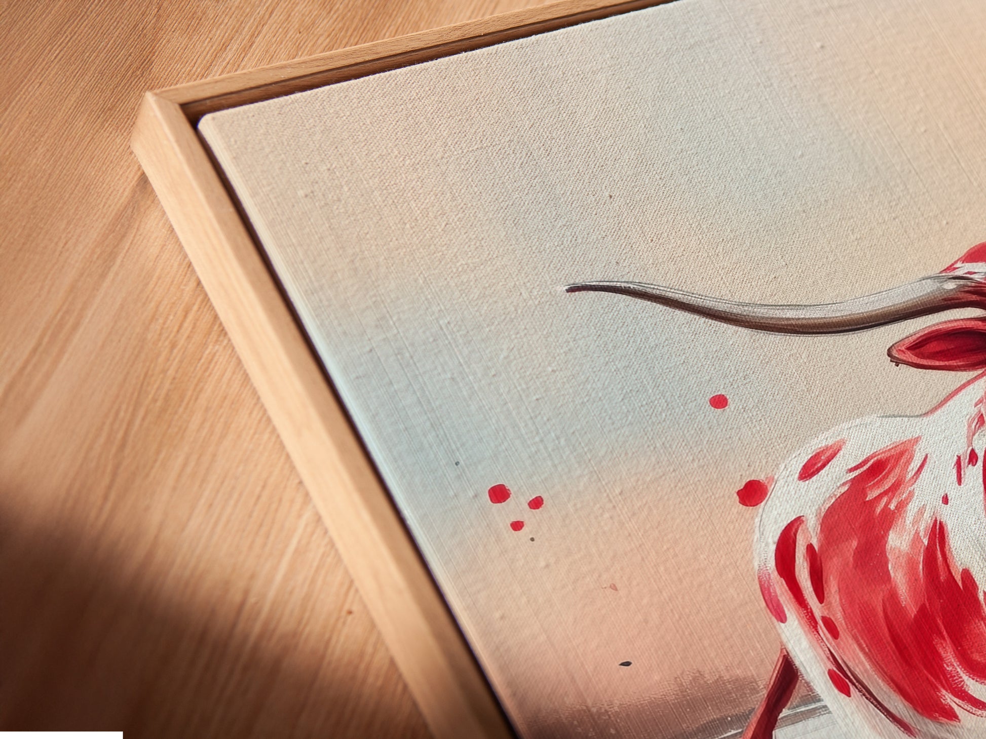 A close-up of Texas Longhorn canvas art in a floating frame. The artwork highlights the vibrant colors of the Longhorn and wildflowers. This piece enhances any farmhouse or country-style decor. Perfect for a rustic touch.