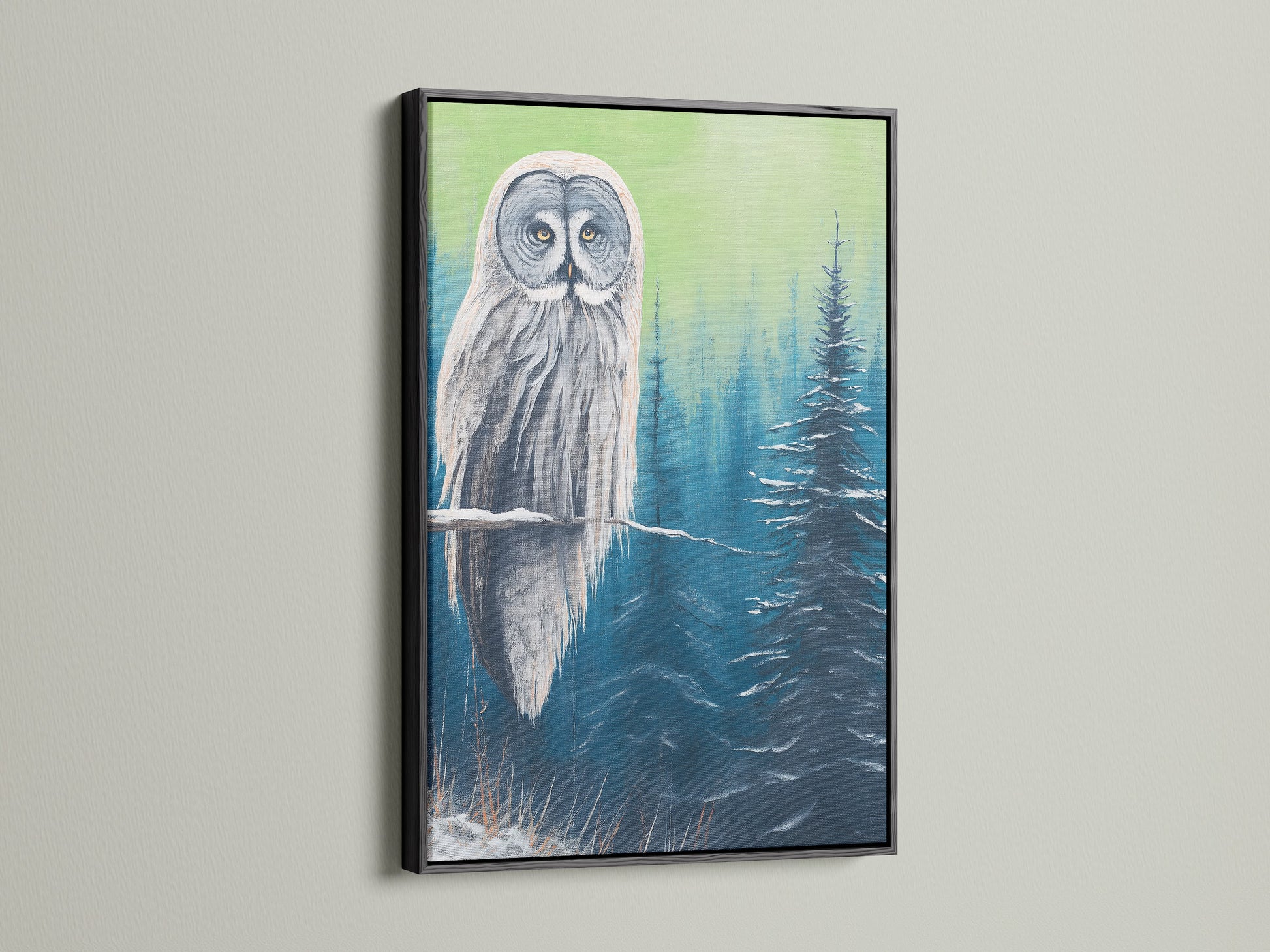 Owl canvas print with a black frame. The contrast of the black frame makes the artwork pop. The owl is perched in a blue and green snowy forest. A striking piece of animal artwork for your home.