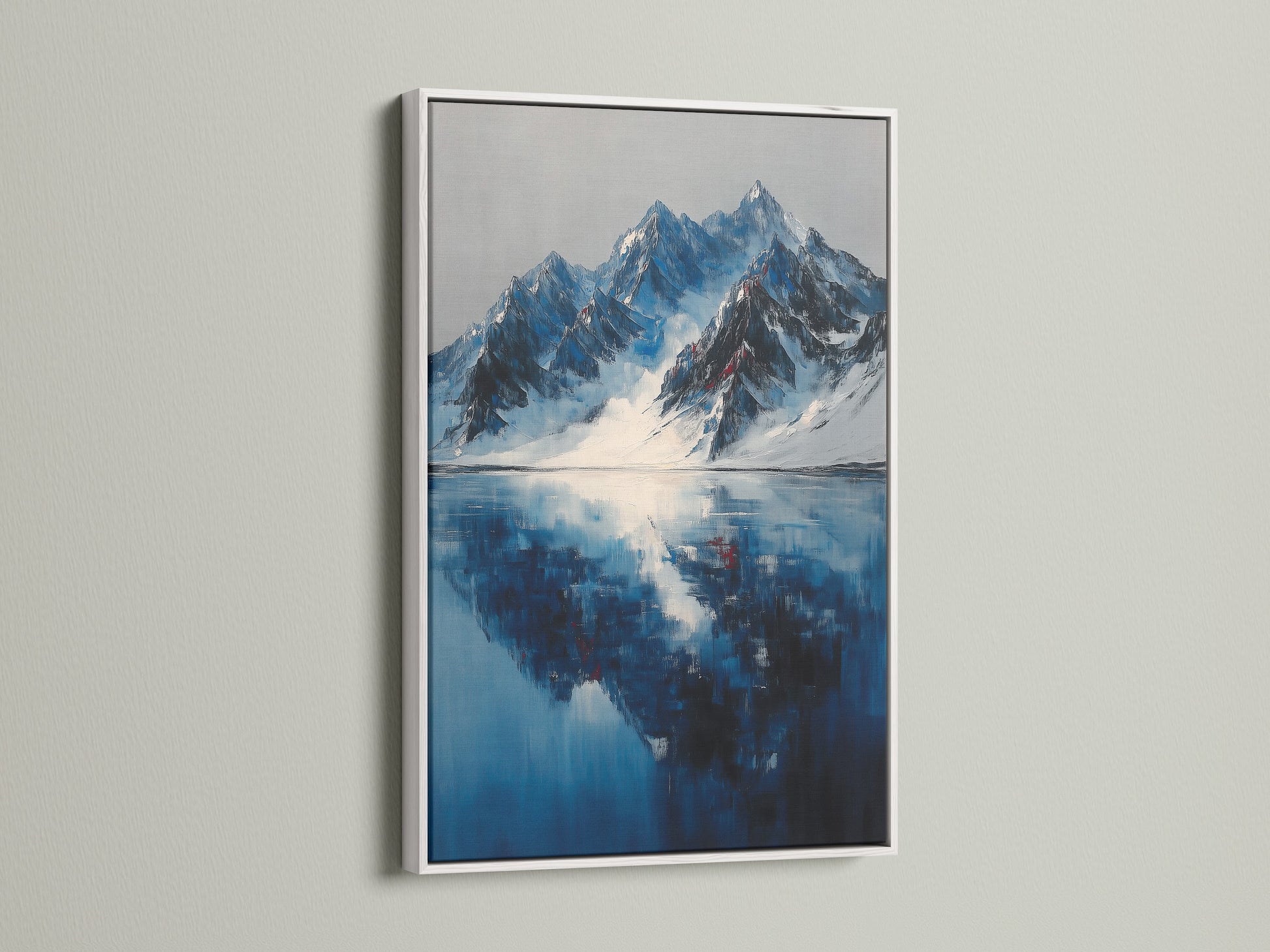 White frame with mountain reflection artwork. This indigo blue lake canvas adds a winter landscape touch to office wall decor.  The white frame complements the blue art print.  It enhances the modern style of the snowy mountains and landscape artwork.