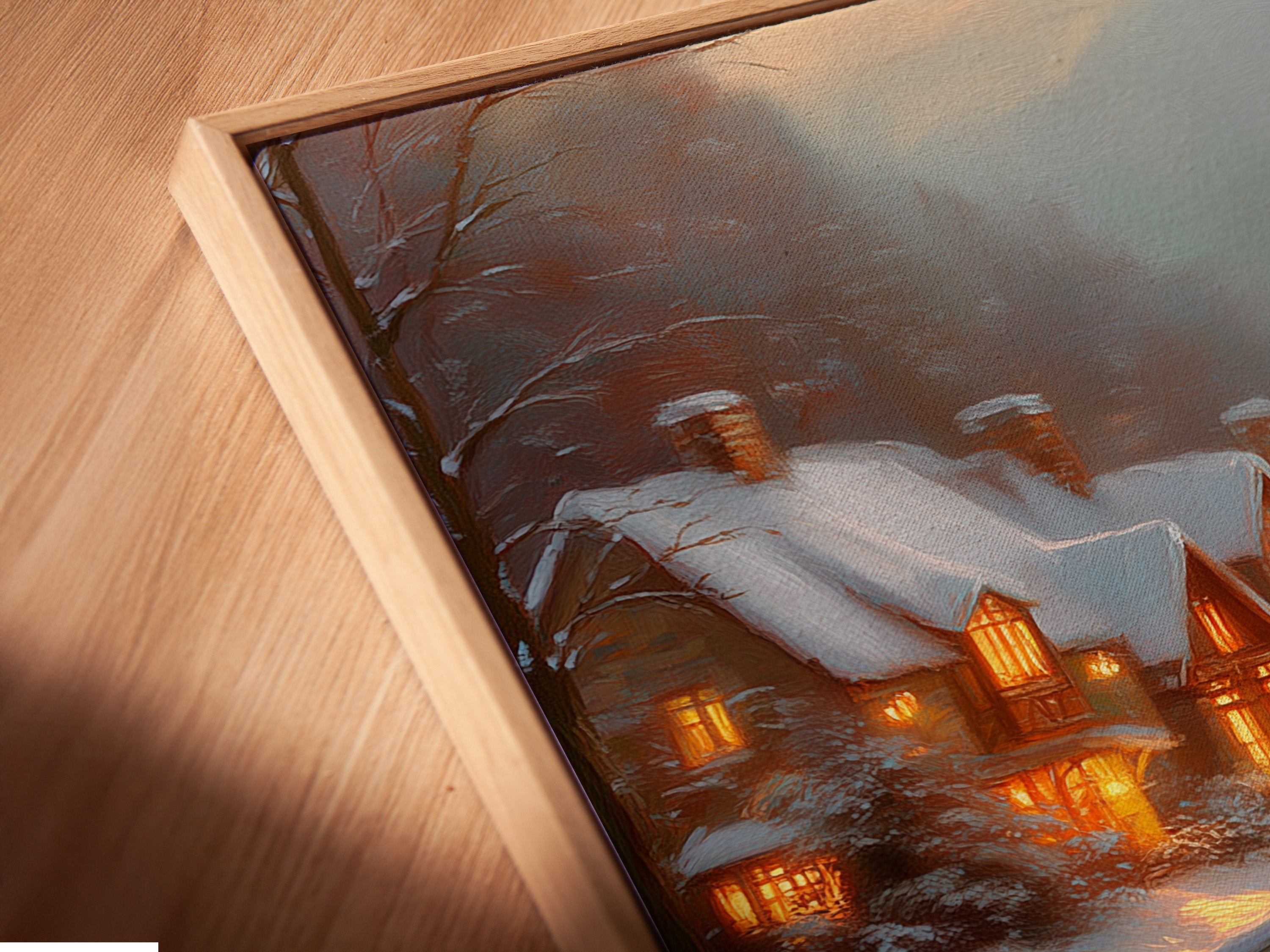 Angled close-up of a Winter Village canvas print in a floating frame. The snowy cottage print showcases a charming bridge landscape. Perfect for adding a festive touch to your home. The floating frame enhances the artwork.