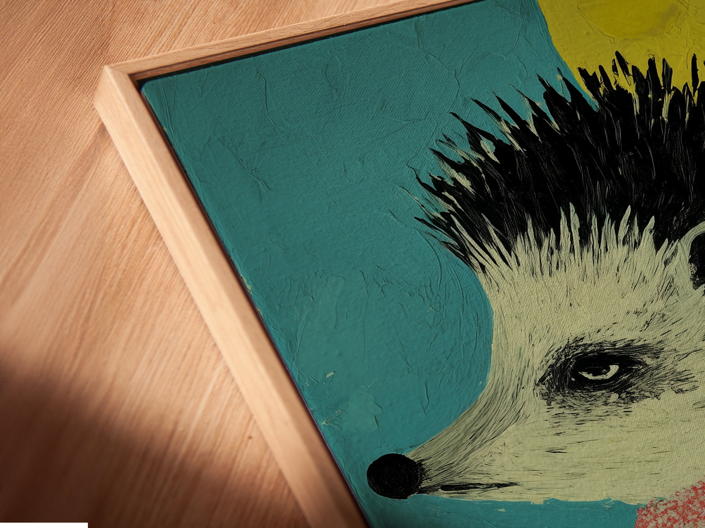 Close-up of a canvas print in a floating frame. The hedgehog art is a whimsical animal canvas wall art. This colorful children's nursery decor is perfect for a playroom. The cute animal art adds a touch of contemporary style.