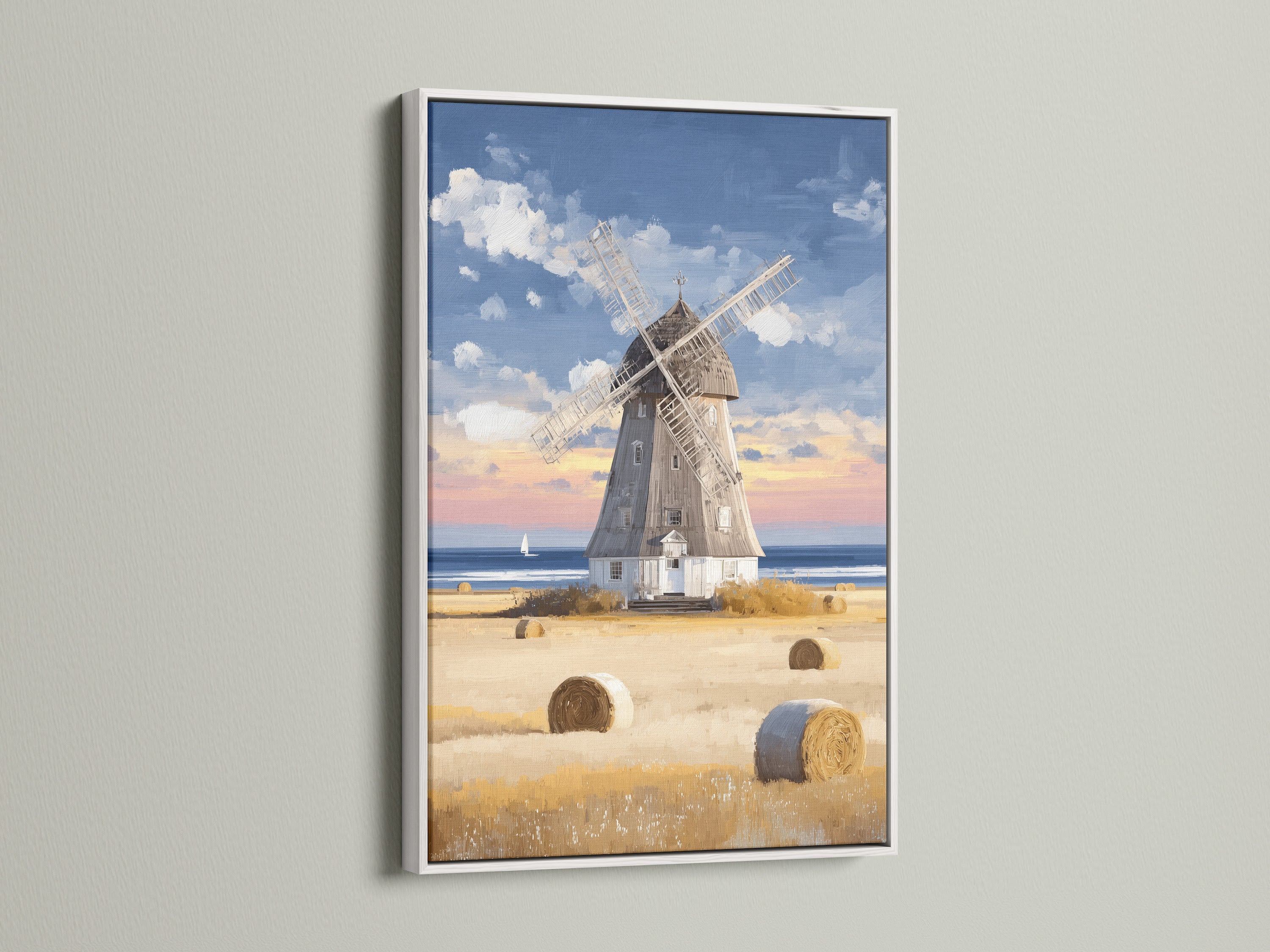This coastal countryside artwork of a windmill in a white frame brings a fresh touch to your decor. The artwork features hay bales and a serene seaside view. Ideal for creating a bright and airy atmosphere in any room it suits farmhouse and modern spaces. This framed art adds a touch of vintage charm.