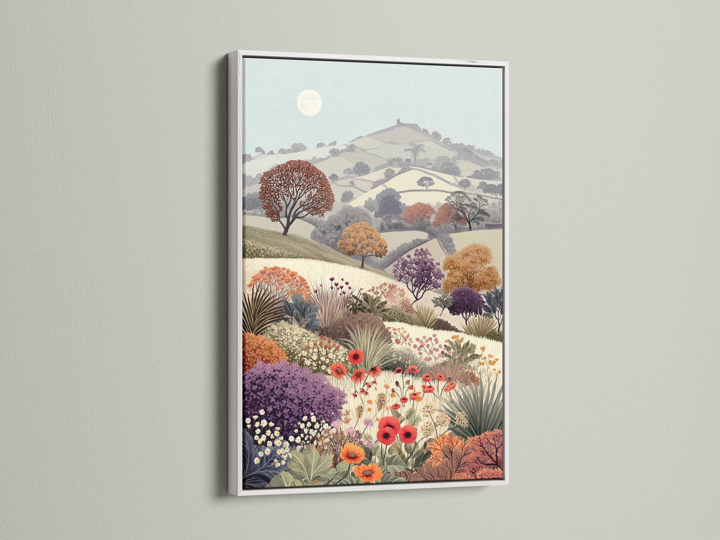 Floral Meadow artwork with a white frame. The vintage landscape features a flower field and countryside scenery. This botanical artwork brings a touch of rural charm. The serene pastel colors and wildflower print add a cottagecore feel to any room. It's ideal for study wall decor and nature enthusiasts