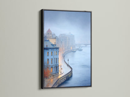 View cityscape river art in a sleek black frame. This European architecture print showcases a misty cityscape. The blue wall art enhances any space. Add urban landscape photography to your office wall.