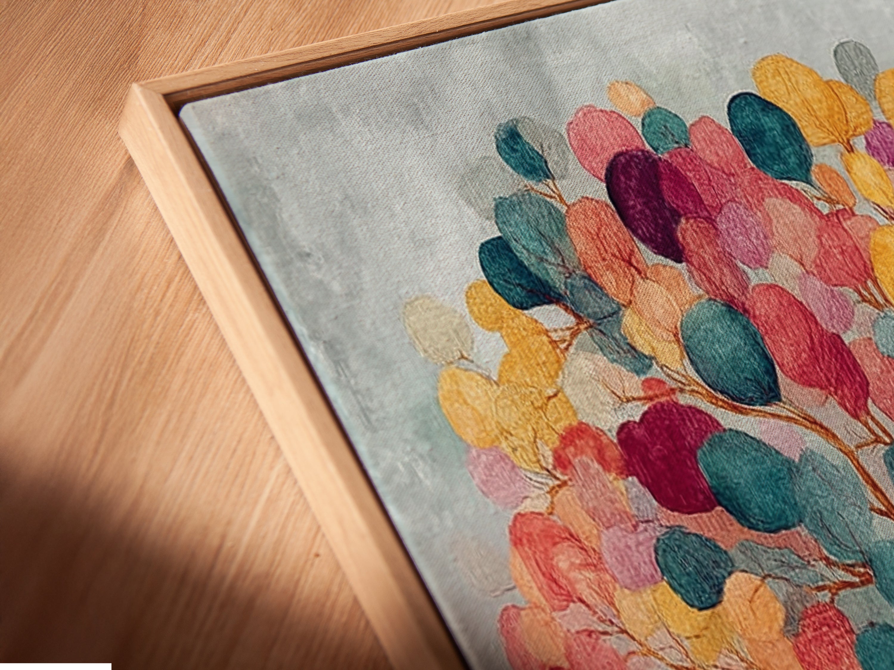 A close-up shot of the canvas print of colorful tree artwork. It features a floating frame. The frame style enhances the modern feel. The abstract botanical wall art is ready to hang. The frame adds depth and dimension.