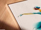 Angled close up of a canvas print in a floating frame. This wall art features a watercolor dance illustration. Perfect contemporary movement artwork for a dance studio. The primary color is blue. The secondary color is gold. It is a fluid art print.