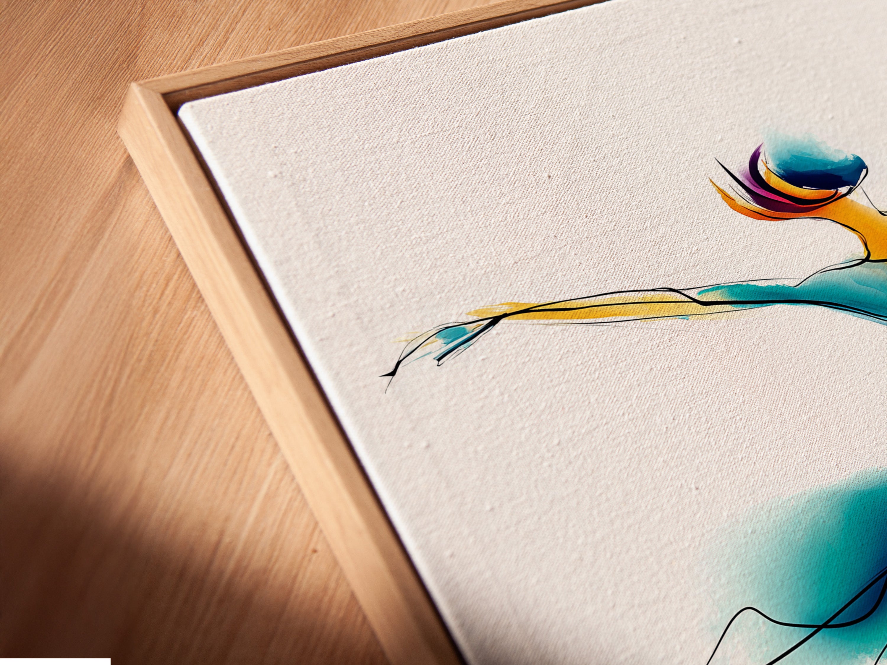 Angled close up of a canvas print in a floating frame. This wall art features a watercolor dance illustration. Perfect contemporary movement artwork for a dance studio. The primary color is blue. The secondary color is gold. It is a fluid art print.