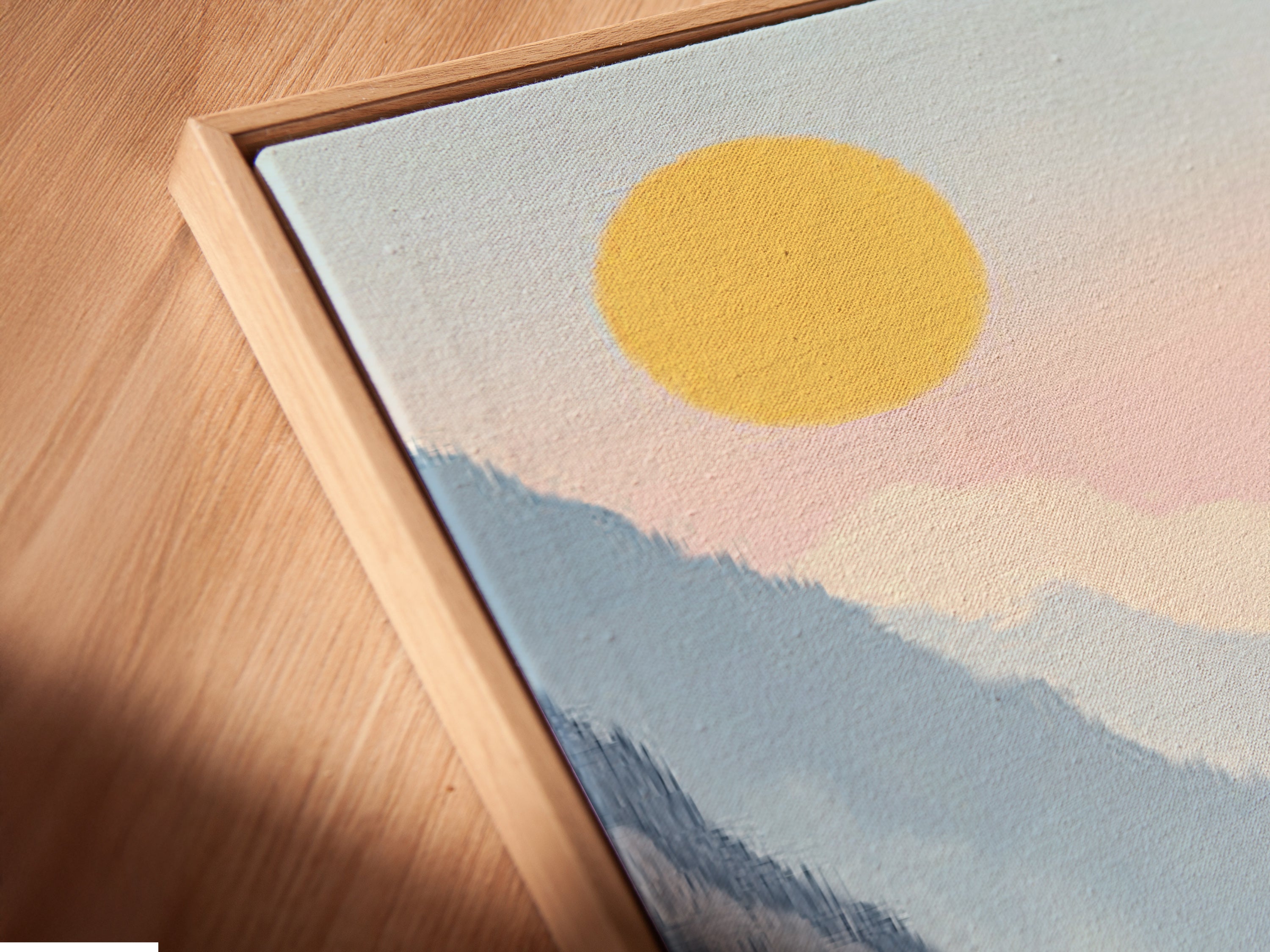 A close-up angled view reveals a canvas print in a floating frame. The mountain lake artwork exudes serene beauty. This valley wall art enhances any space with its pastel landscape. Perfect for adding a modern touch to your office or home decor. Discover tranquil art.