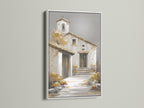 Artwork with a white frame. The artwork features a quaint building. It looks like a church or villa. The artwork is matted and framed. The white frame is simple and elegant. This framed artwork is a great way to decorate your home.