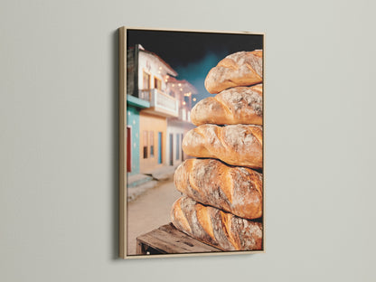 A stack of freshly baked bread is displayed inside an oak frame. This rustic bakery wall art enhances kitchen decor. It creates a warm inviting atmosphere. Perfect for food photography enthusiasts.
