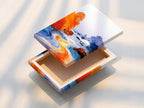 This is a stretched canvas print featuring a coastal seascape. The orange and blue ocean art creates a modern beach landscape. This stretched canvas is ready to hang and enjoy. Perfect for adding a touch of the seaside to your living space. Shop now