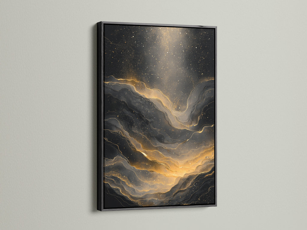 The artwork is framed in black. The art is an abstract black and gold. The black frame enhances the art. It adds a dramatic touch to any room. The dark frame contrasts beautifully with the art. The frame provides a sleek and modern look to the piece.