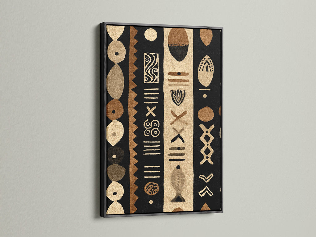 A bold black frame highlights a tribal-inspired artwork. The artwork uses a palette of black brown and beige. The black frame adds definition to the art. This piece is perfect for a contemporary setting.