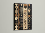 A bold black frame highlights a tribal-inspired artwork. The artwork uses a palette of black brown and beige. The black frame adds definition to the art. This piece is perfect for a contemporary setting.