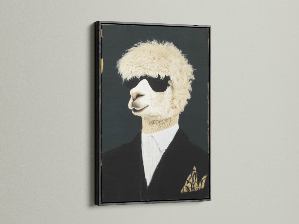 Cool Llama Art Print in a black frame hangs on a white wall. This quirky animal wall art features a llama wearing sunglasses and a suit. The black frame creates a bold statement. Perfect formal portrait canvas print for office wall decor.
