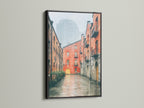 The black frame provides a striking contrast to the Brick Building Canvas Print. The urban landscape artwork is suited for minimalist and urban spaces. It is a great choice for homeowners renters and business owners.