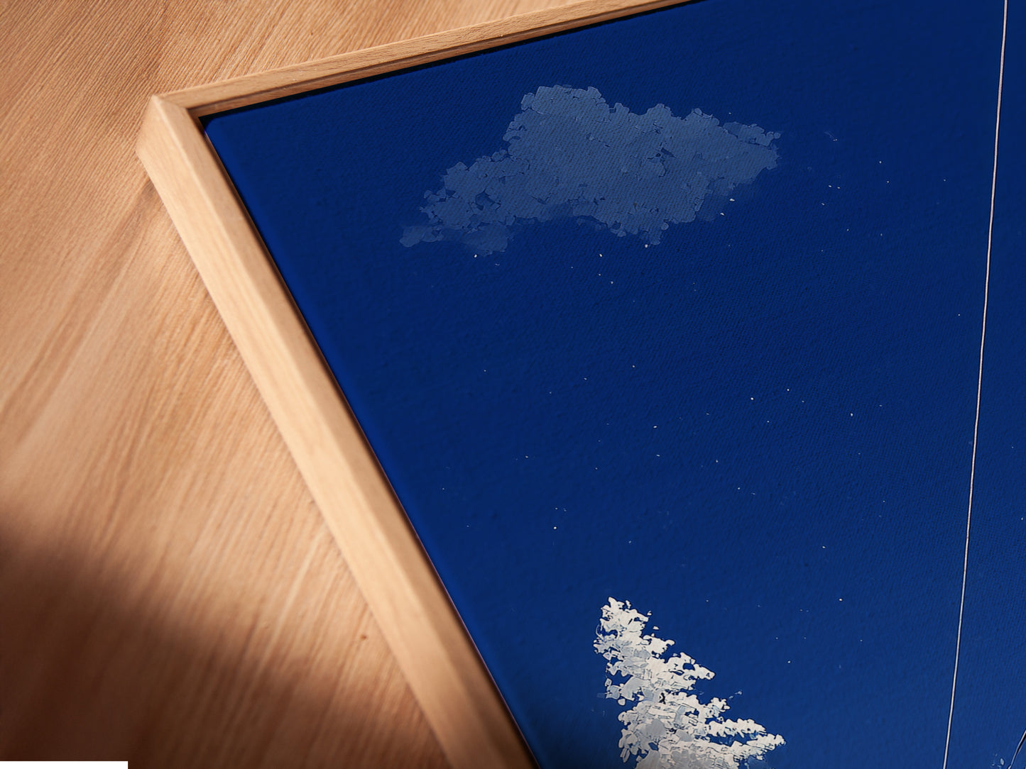Close-up of a canvas print in a floating frame. The ski lift artwork features a winter mountain scene. The alpine cable car adds a touch of adventure. This piece is perfect for cabin decor. The floating frame gives the art a modern and stylish look. It enhances the snowy landscape.