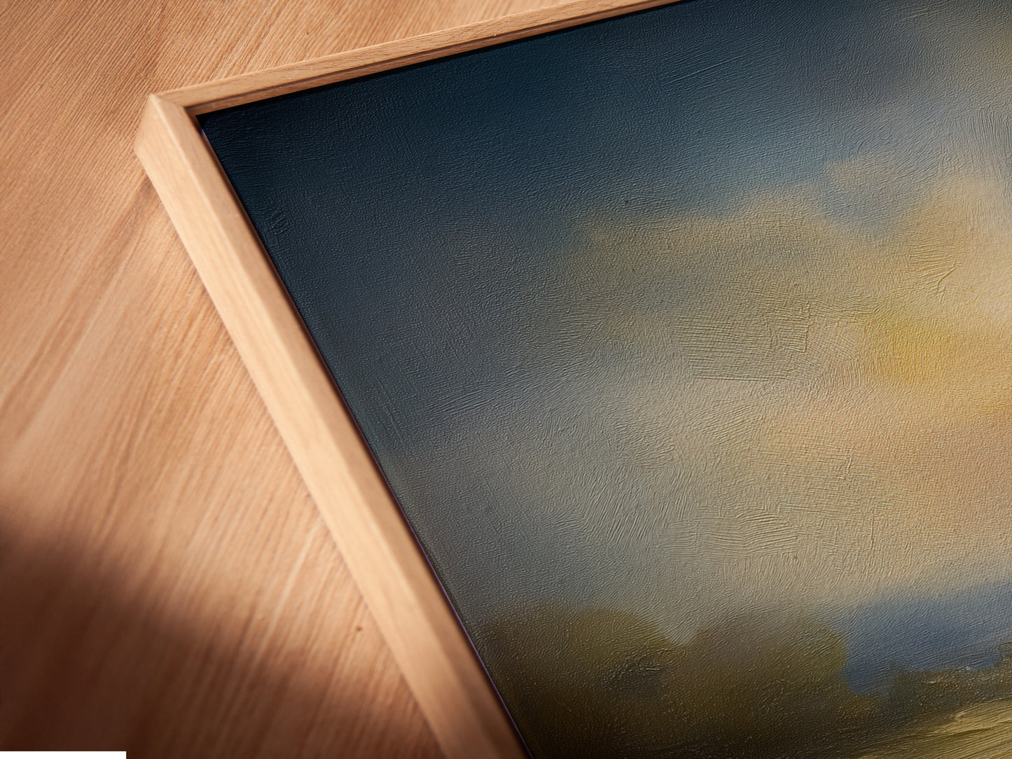 A close-up angled view shows a canvas print in a floating frame. The artwork features an impressionist landscape painting. The frame adds a modern touch to this golden meadow artwork. It is ready to hang.