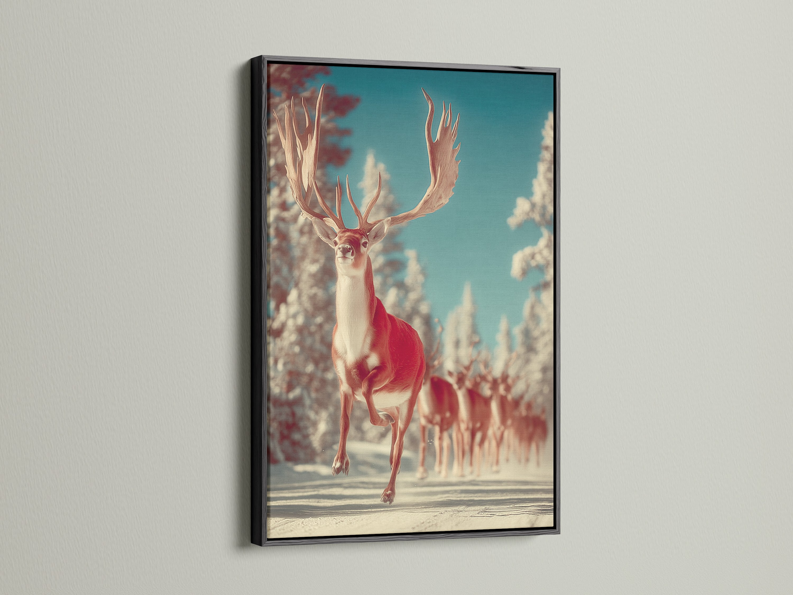Winter Deer canvas art in a black frame hangs on a white wall. This stag artwork brings forest animal art to your walls. It's a unique wildlife print that captures the essence of winter. A great choice for seasonal decor adding a touch of rustic charm.