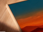 A close-up angled view reveals a canvas print in a floating frame. The mountain sunset artwork is beautifully displayed. The floating frame enhances the depth and dimension of the piece. It's a modern and stylish way to showcase nature photography. Perfect for adding a touch of rustic elegance to your space.