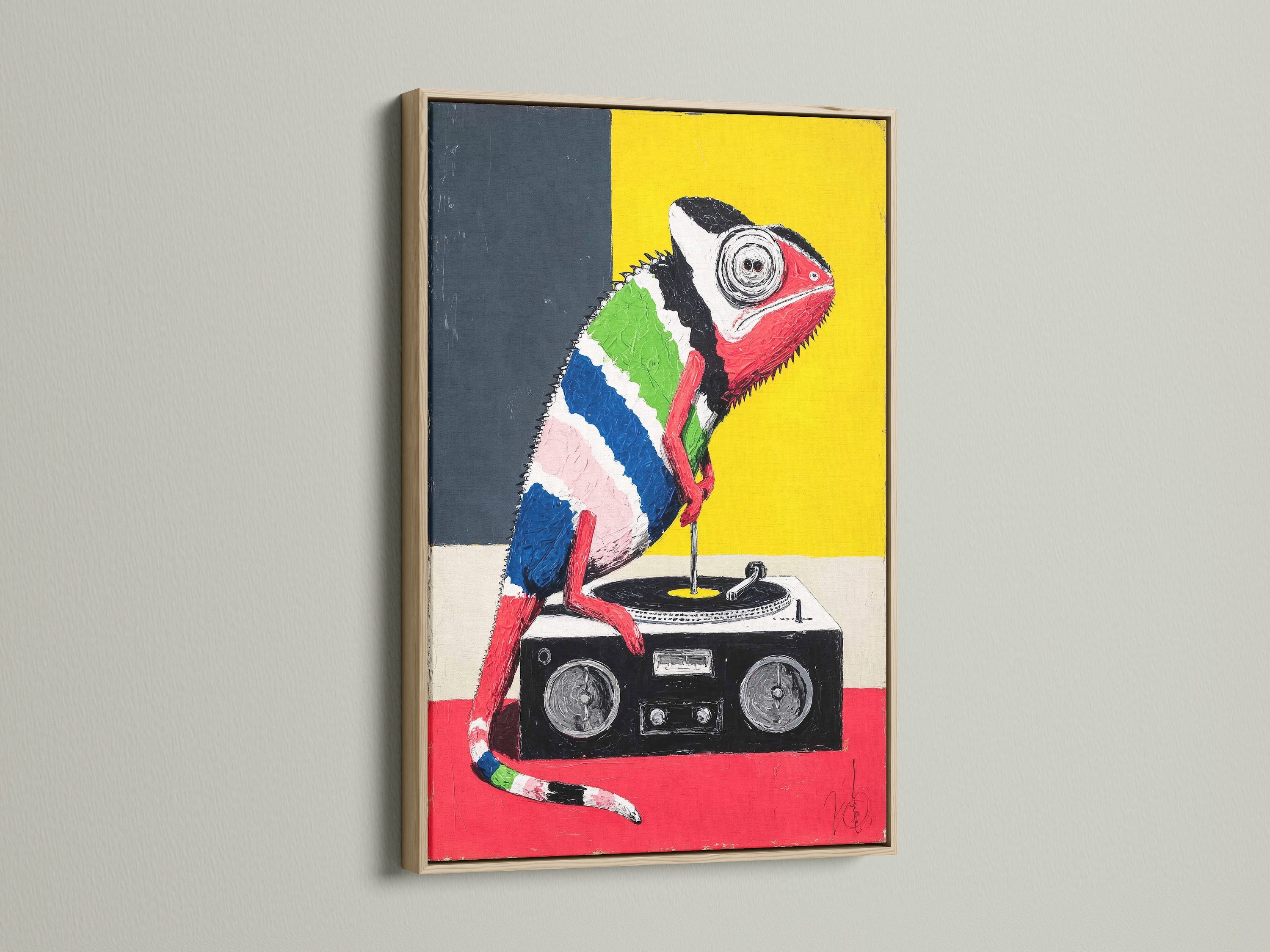 A vibrant chameleon art print is showcased in an oak frame. This music lover wall art is a great gift for DJs. The retro pop art style will brighten up any room.