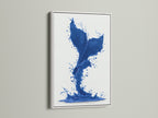 A vibrant cobalt blue whale tail artwork. The artwork is encased in a clean white frame. This nautical splash print is ideal for bathroom decor. Its refreshing aesthetic enhances any room.