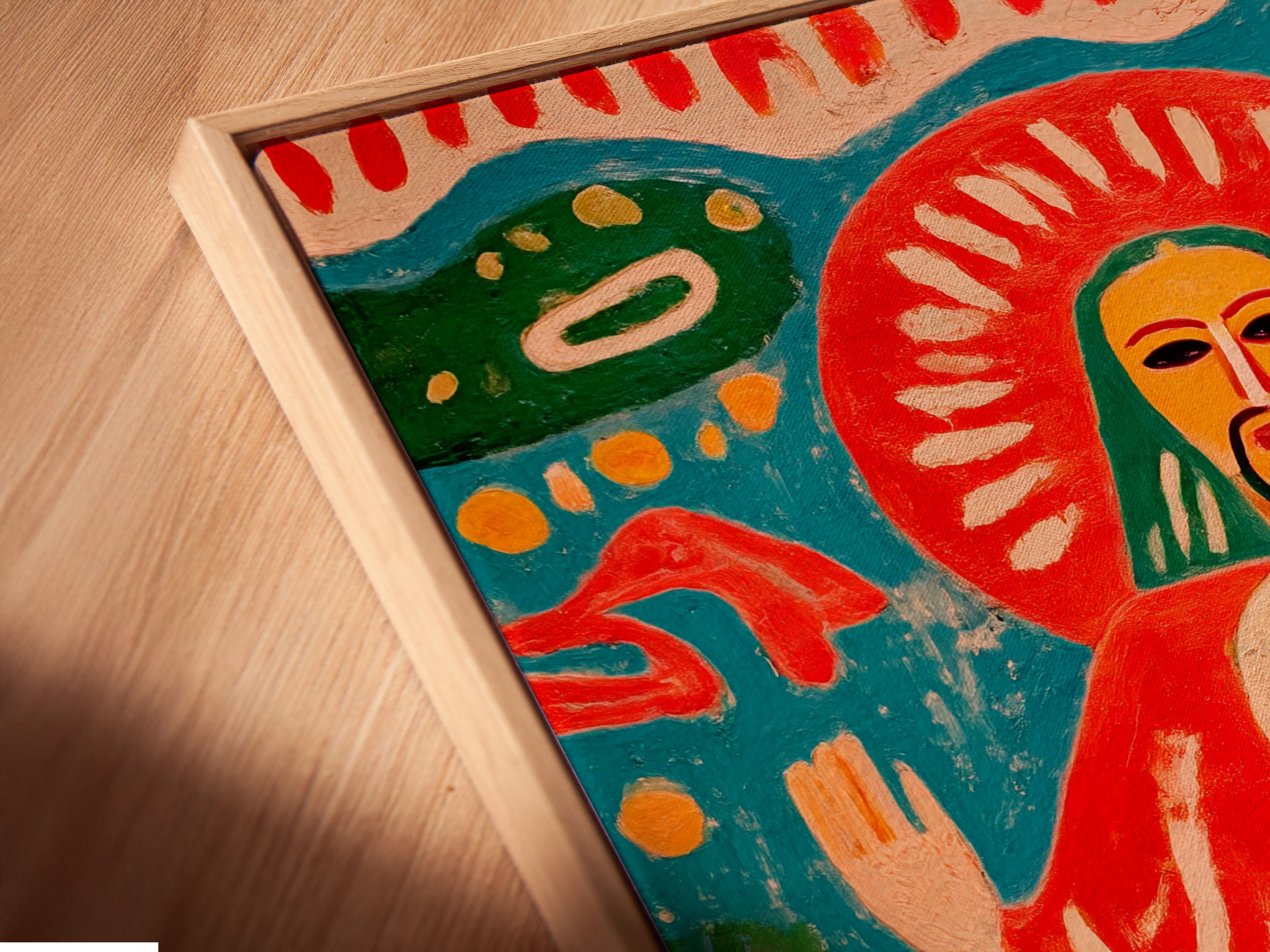 Angled close up of a canvas print in floating frame. This sacred heart artwork is vibrant. The folk art canvas print is colorful. This religious artwork offers spiritual decor. The bohemian eclectic style is a great addition.