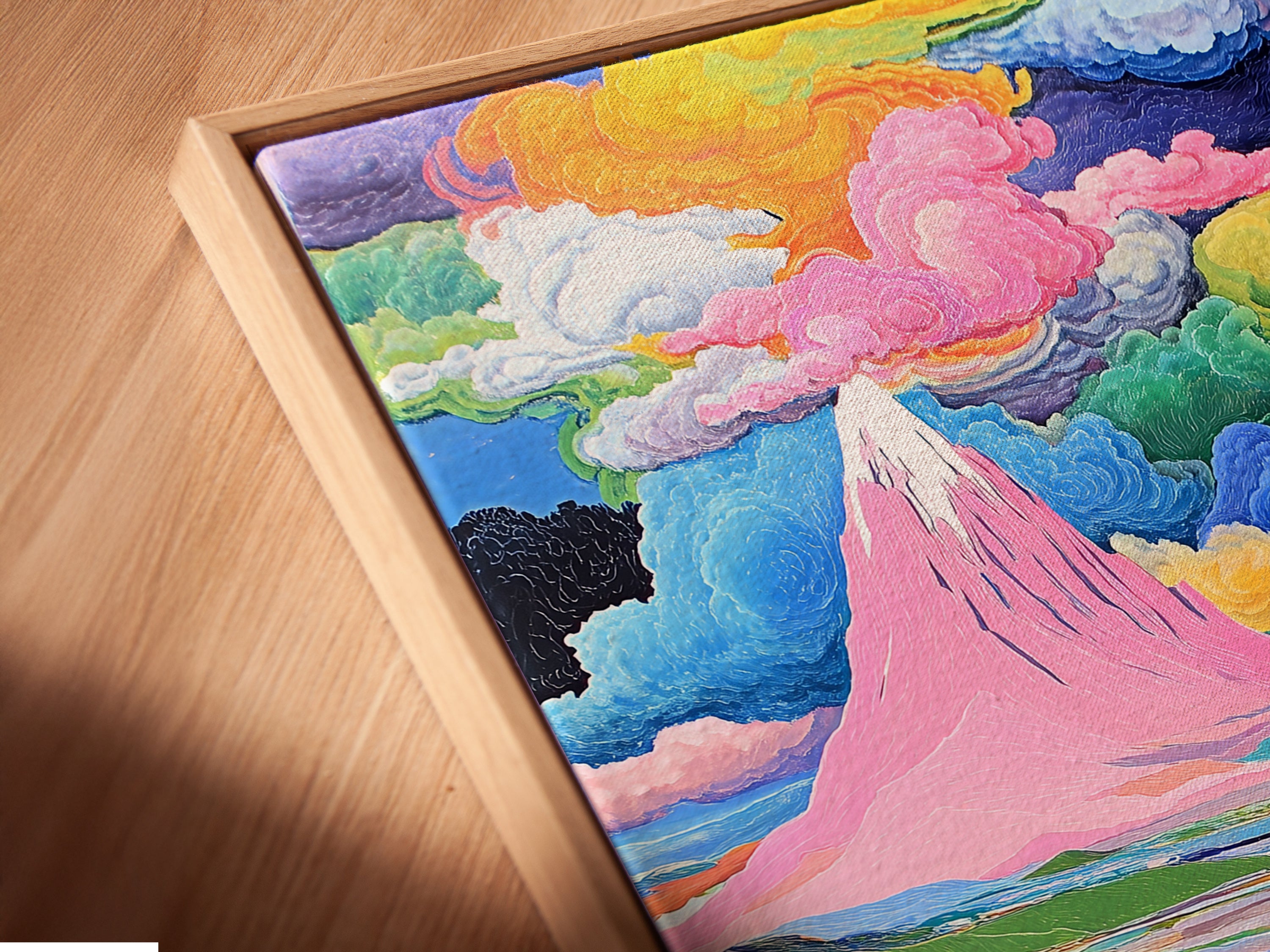 A close-up angled view of a canvas print in a floating frame. The artwork features a colorful mountain landscape. The whimsical nature scene includes pink and teal hues. This modern art piece is perfect for contemporary wall decor.