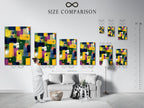 A size comparison chart is shown in an interior setting. The chart helps visualize how different sizes of abstract colorful artwork will look in your home. The artwork is a modern geometric print with brushstrokes in yellow blue and purple.