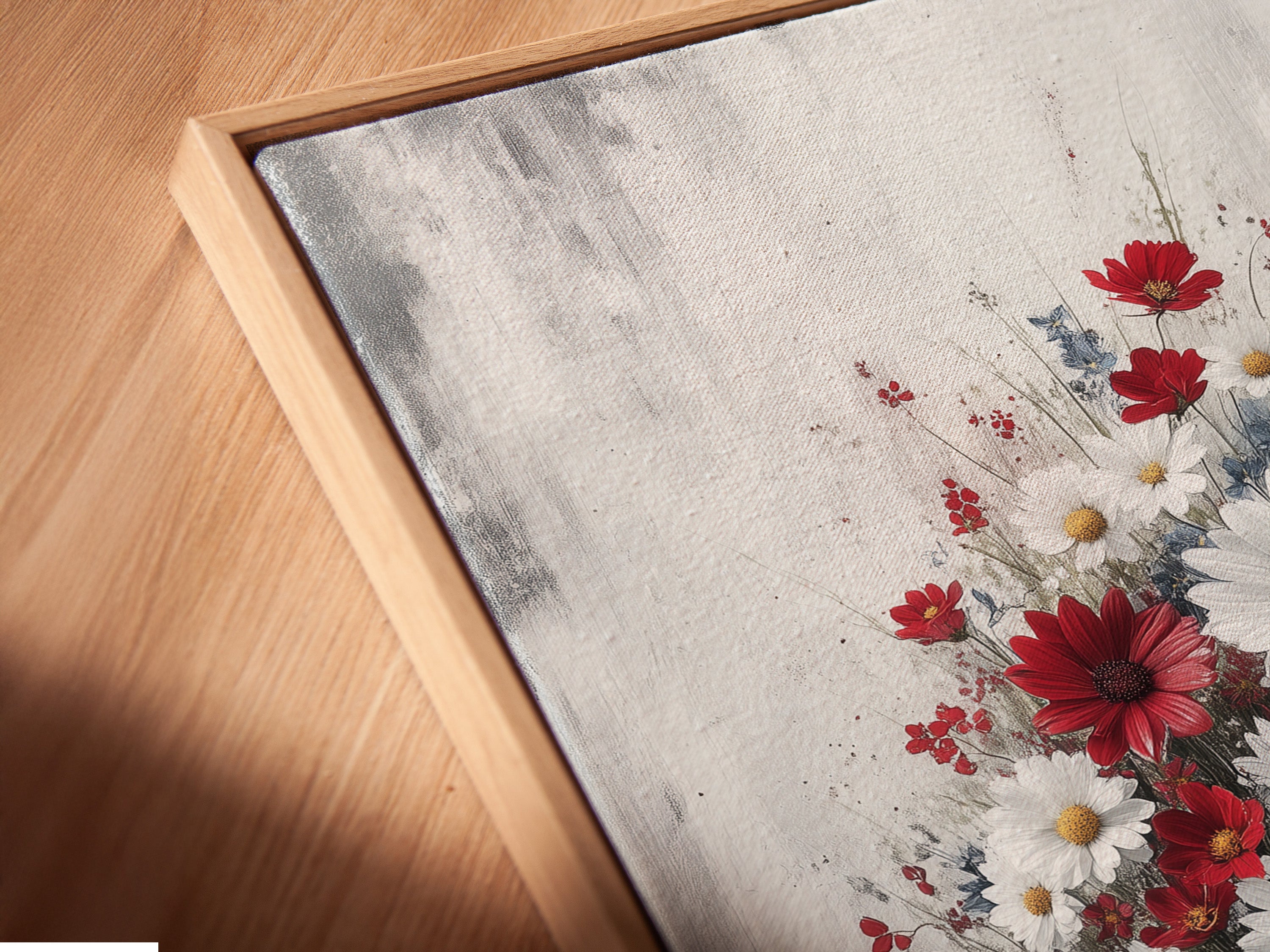 Close-up of a canvas print in a floating frame. This artwork features a vintage bathtub filled with red and white flowers. The floating frame enhances the artwork's rustic charm. Perfect for farmhouse-style bathroom decor.