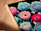 A close-up angled view shows a canvas print in a floating frame. The modern floral artwork features vibrant teal pink and yellow flowers. This colorful flower canvas is perfect for any room. It adds a touch of modern botanical beauty. Enhance your space with this eye-catching flower print. The black background makes the colors pop.