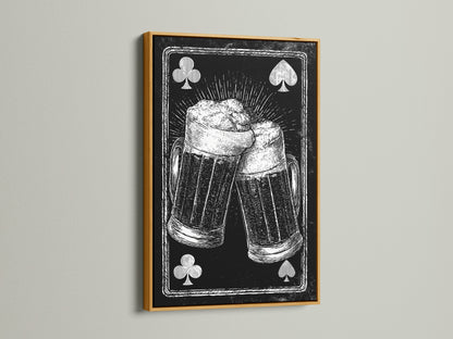 Framed artwork featuring a playing card beer mug art print. The artwork is framed in a gold frame. The gold frame brings a touch of elegance. It enhances the artwork's vintage charm. Suitable for a classic interior.