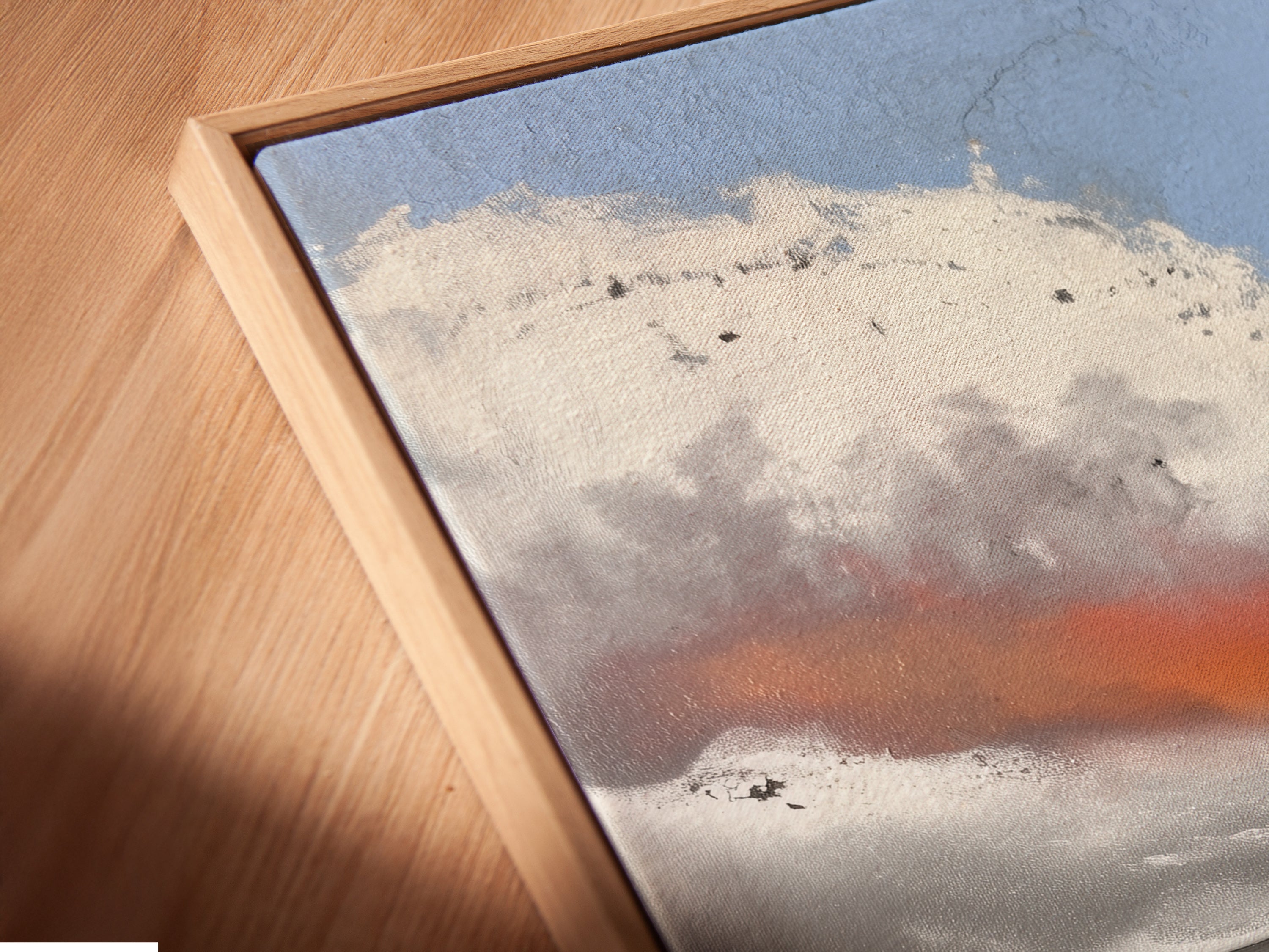Angled close-up of a canvas print in a floating frame. This coastal artwork features a red boardwalk. The seascape painting adds depth and dimension to your wall. It's perfect for creating a focal point in your living room or bedroom. Enjoy the beauty of beach decor.