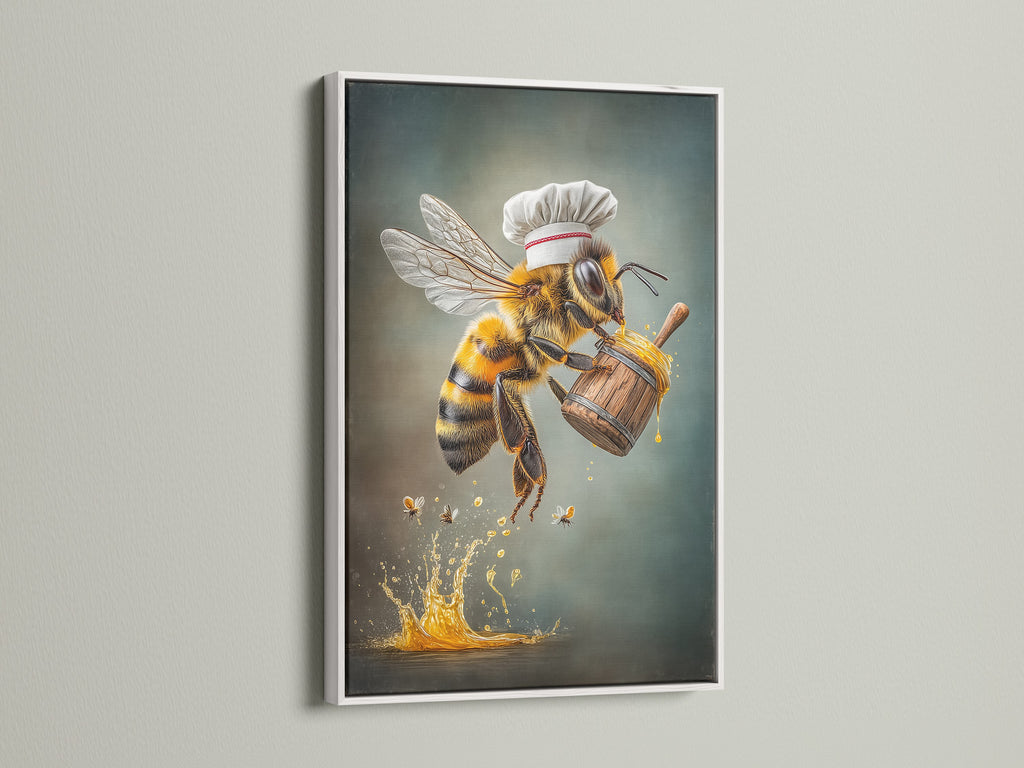 Chef Bee artwork displayed in a white frame. The honey bee chef poster brings charm to any kitchen. It is a perfect whimsical addition to your dining room or restaurant decor. Explore this delightful kitchen canvas art today.