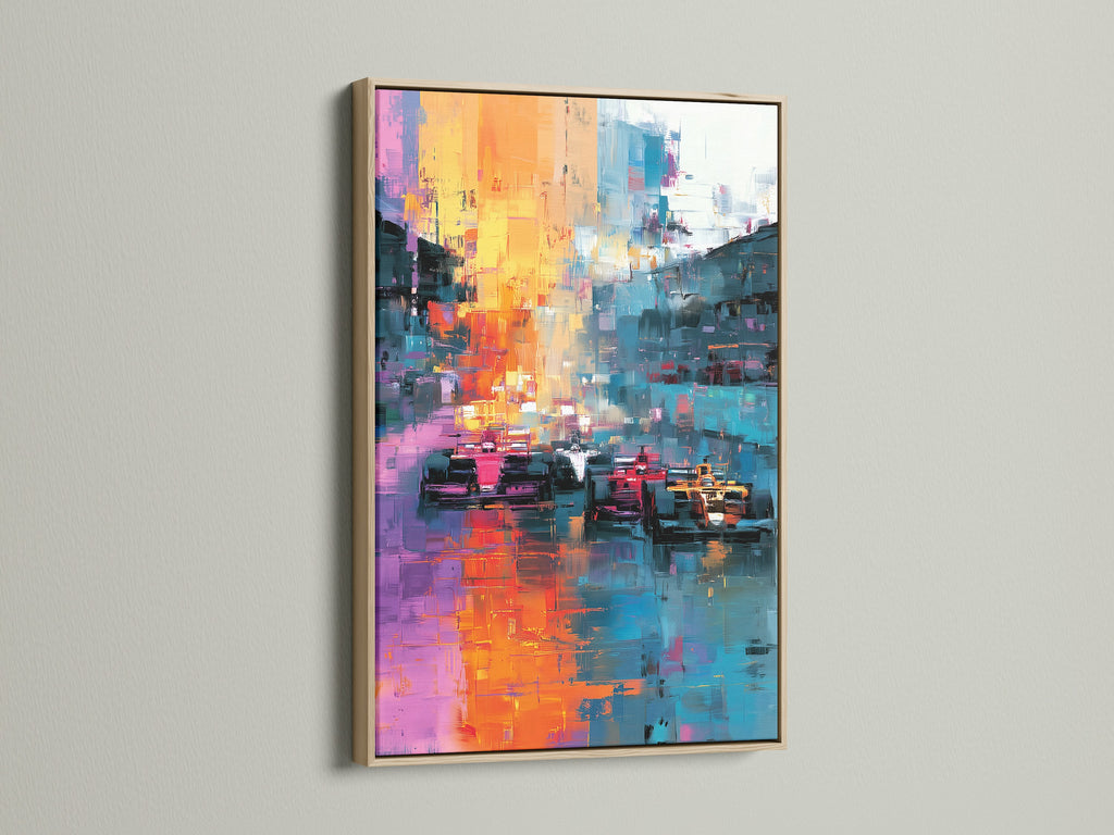 This image displays an abstract artwork with race cars framed in oak. The art is mounted on a clean white wall. The art piece adds a touch of sophistication to any room. The oak frame enhances the artwork's colors.
