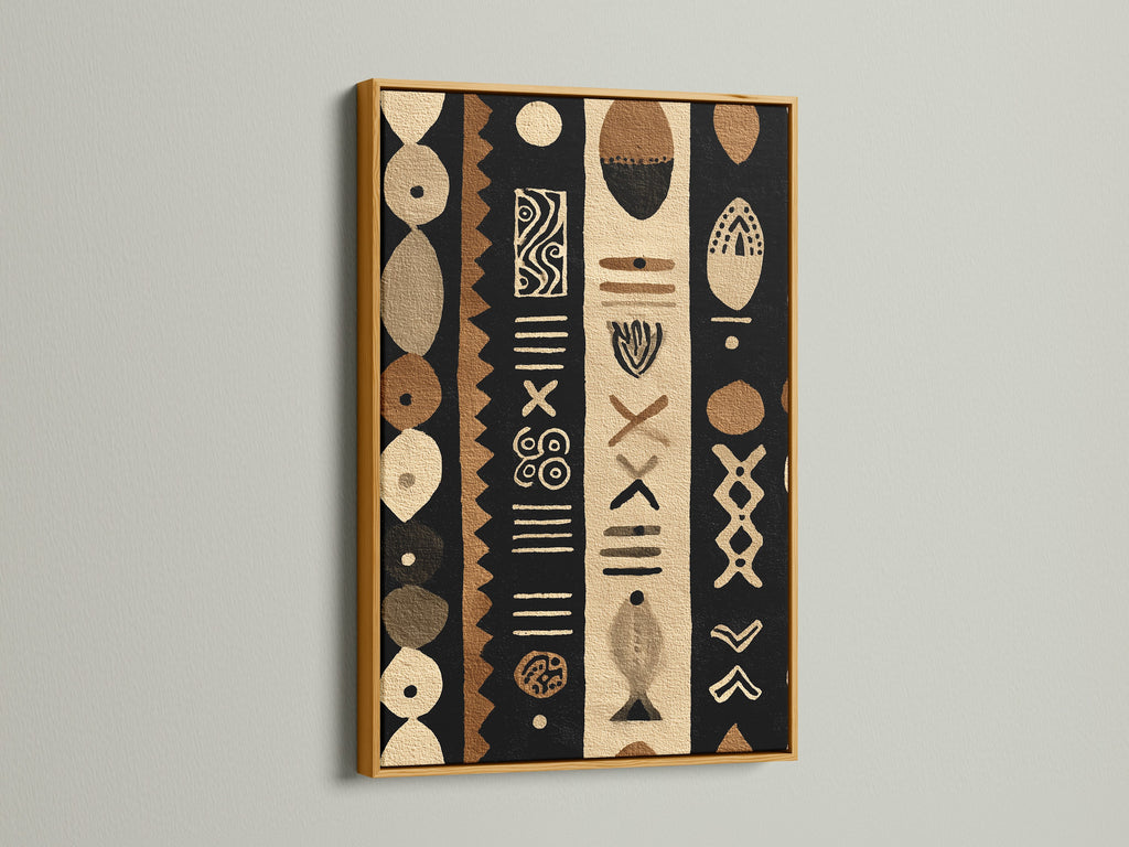 A luxurious gold frame elevates a tribal artwork. The artwork is composed of black brown and beige tones. The metallic sheen of the gold frame catches the light. It adds a touch of opulence to any interior decor.