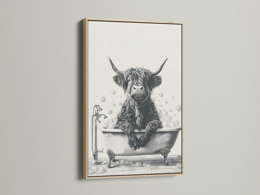 Highland Cow in Tub Canvas Print with an oak frame. A charming piece of bathroom wall art featuring a Scottish cow. This farm animal art brings a rustic touch to any room. The cow enjoys a bubble bath. It is a perfect addition to farmhouse decor. The artwork makes a unique statement. 