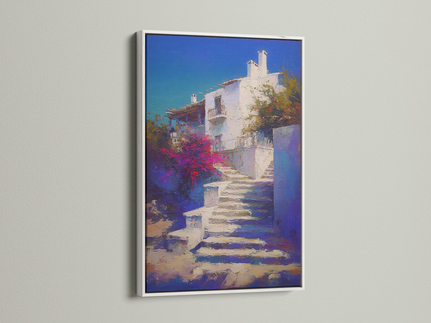 Mediterranean Village artwork with a white frame. This Greek Island staircase print provides coastal wall decor. Blue and white artwork is ideal for a bedroom. The frame enhances the artwork's beauty.