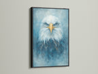 The stunning eagle portrait is framed in sleek black. The artwork features a majestic bird with piercing blue eyes. It brings a modern touch to any space. This captivating wildlife art complements minimalist Scandinavian or contemporary styles.
